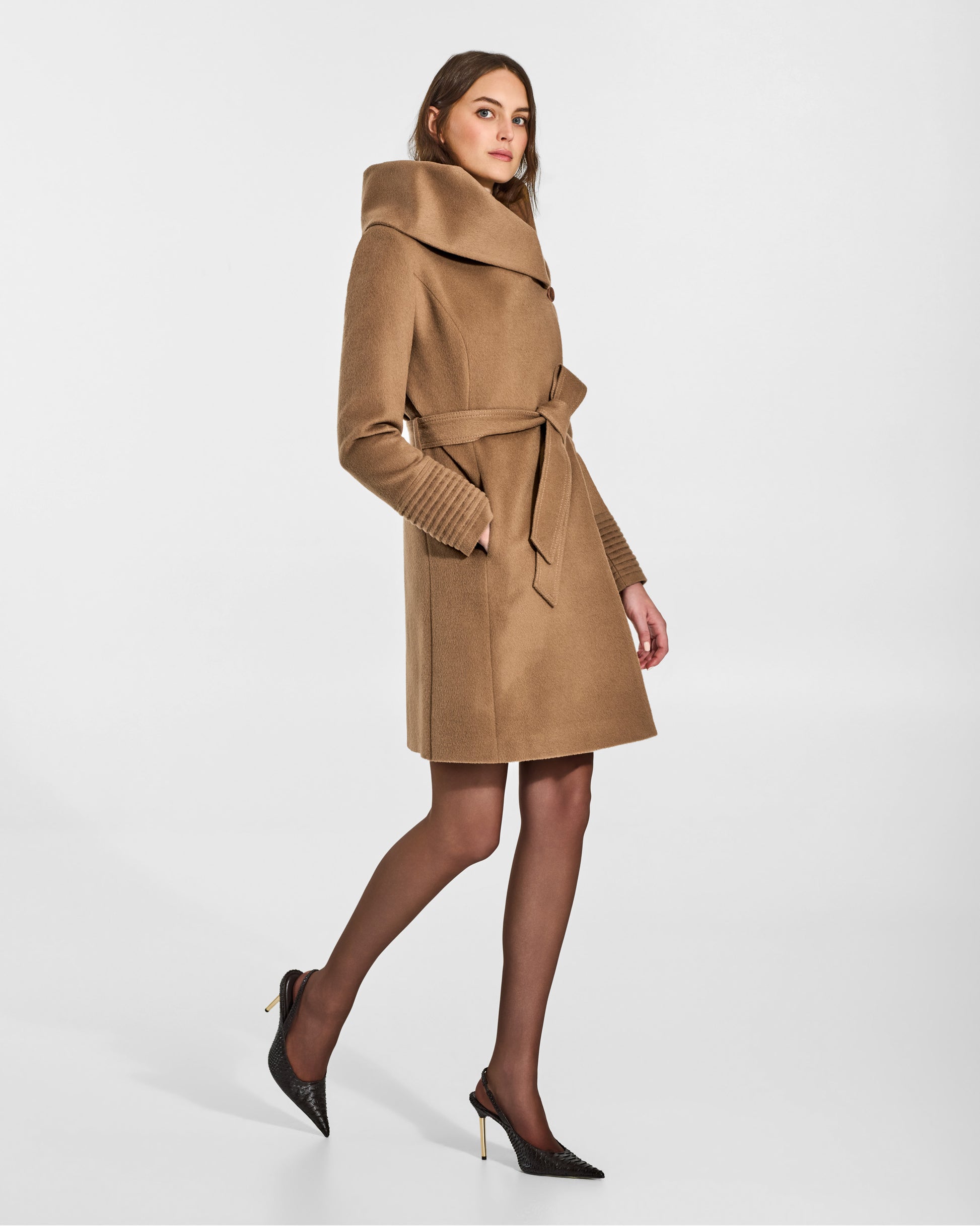 SENTALER Mid Length Hooded Wrap Coat in Dark Camel, Baby Alpaca. Worn by a female model, side view, belted.