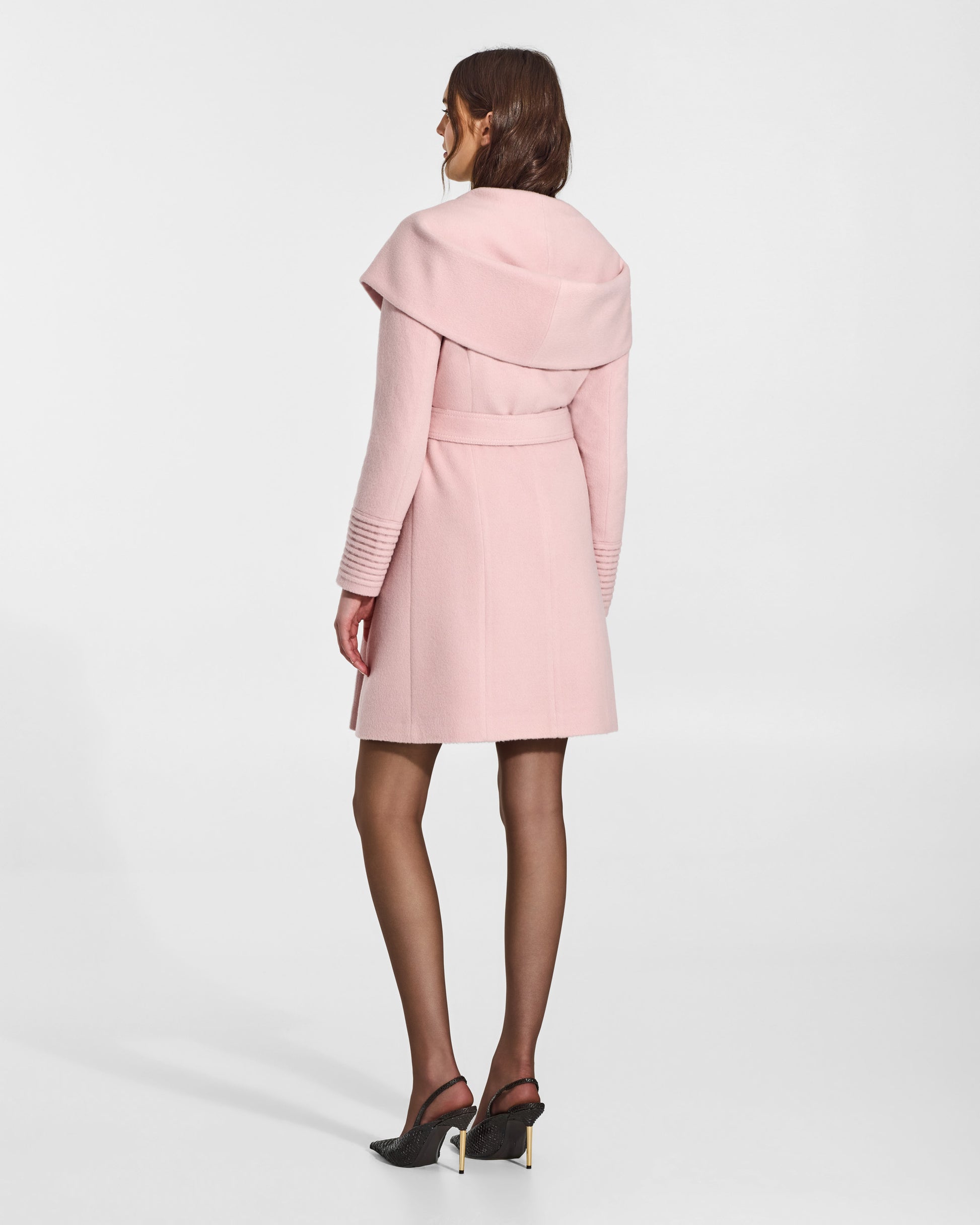SENTALER Mid Length Hooded Wrap Coat in Pink Frost, Baby Alpaca. Worn by a female model, back view, belted.