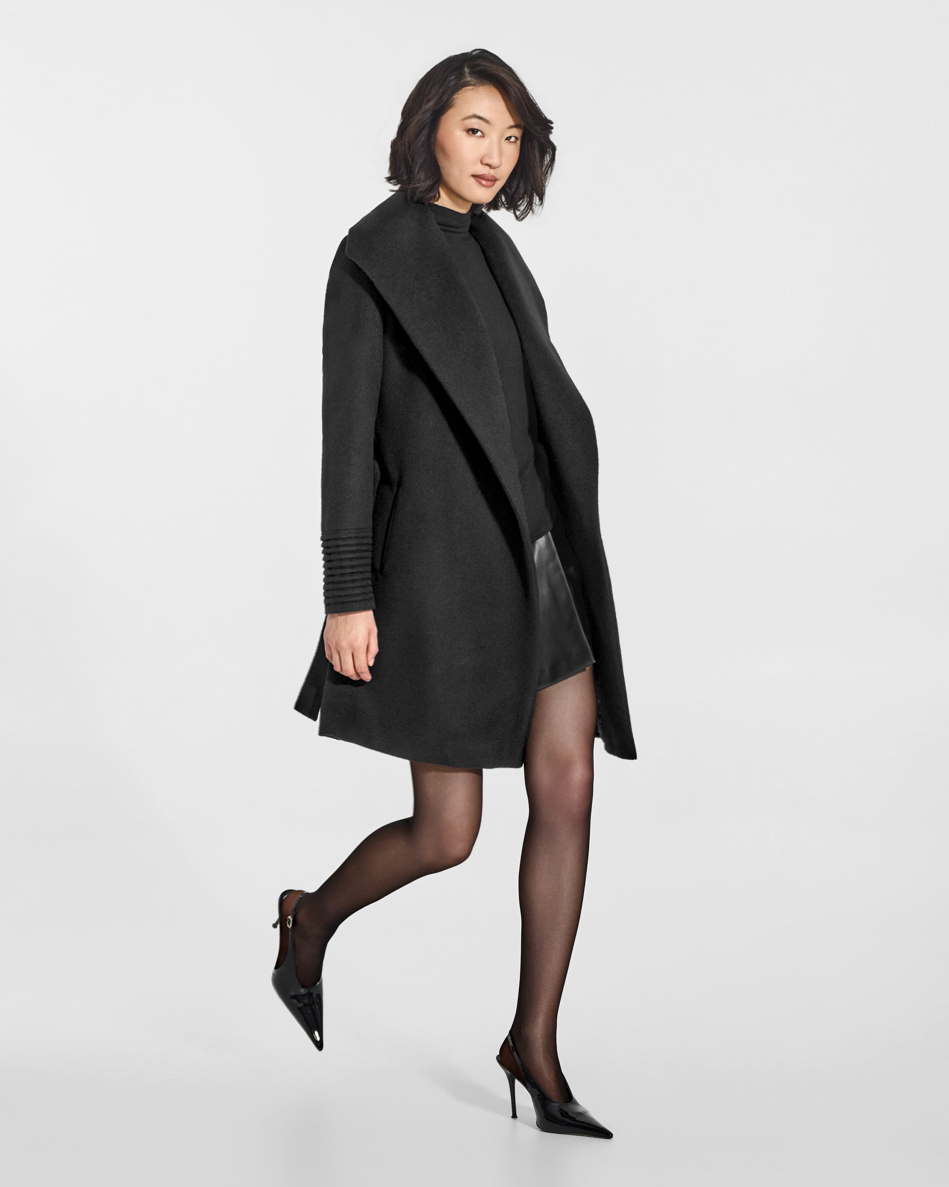 SENTALER Mid Length Shawl Collar Wrap Coat in Black, Baby Alpaca. Worn by a female model, side view, open.