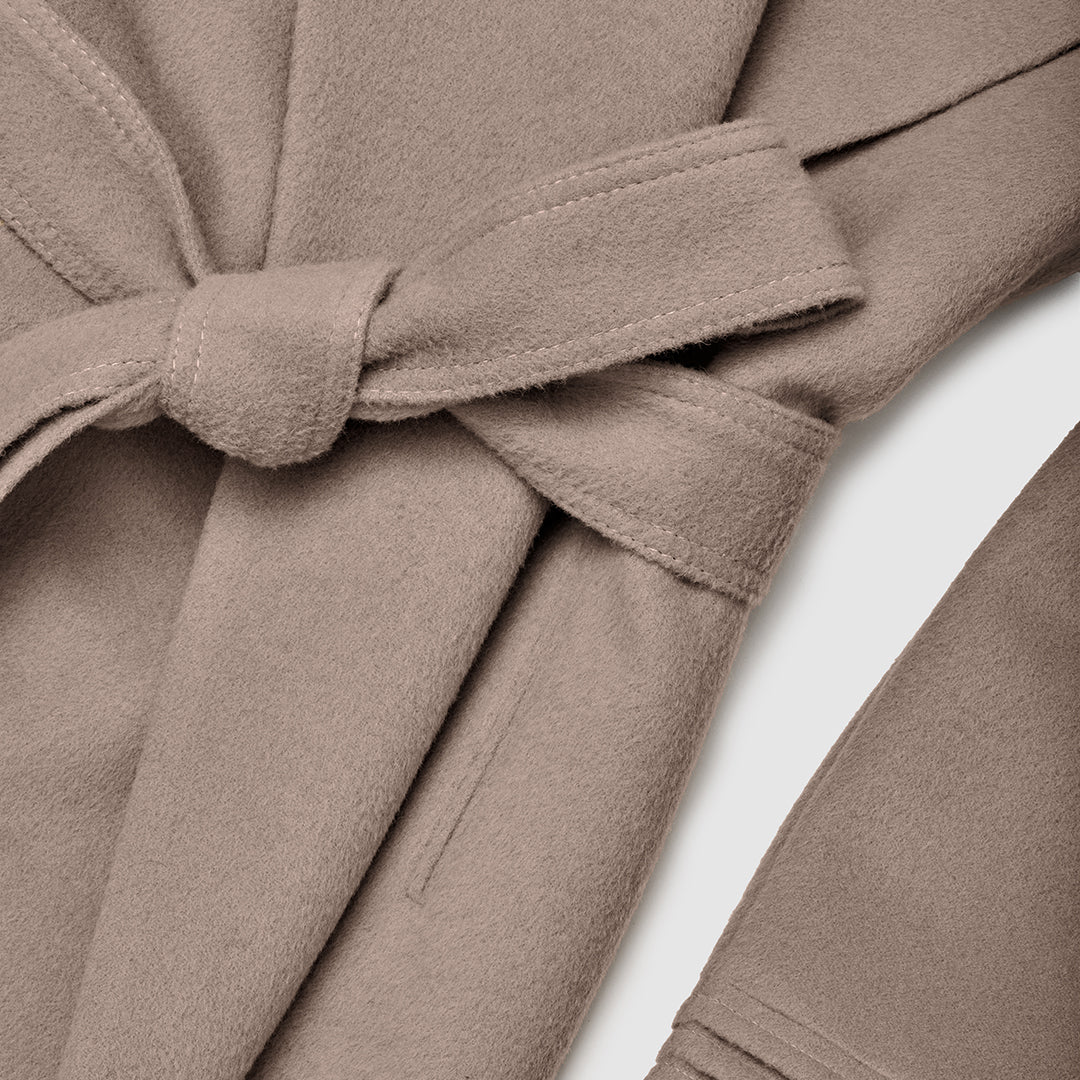 SENTALER Mid Length Shawl Collar Wrap Coat in Warm Taupe, Baby Alpaca. Flat lay, close-up of garment, belted.