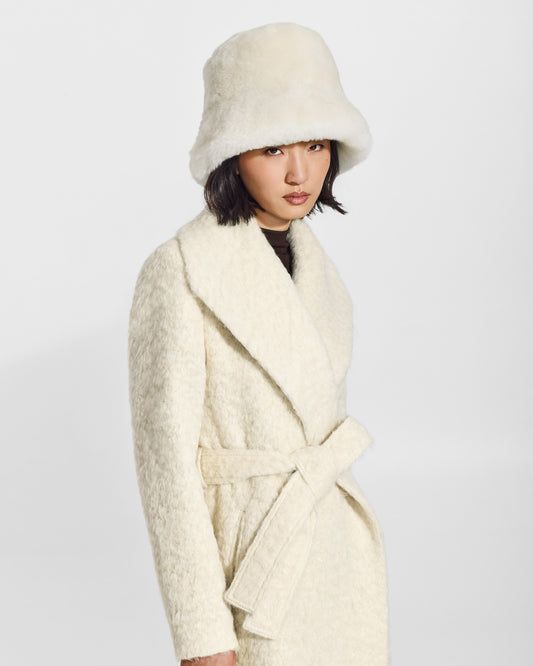 SENTALER Oversized Shearing Bucket Hat in Ivory, Alpaca Shearling. Worn by a female model, side view.