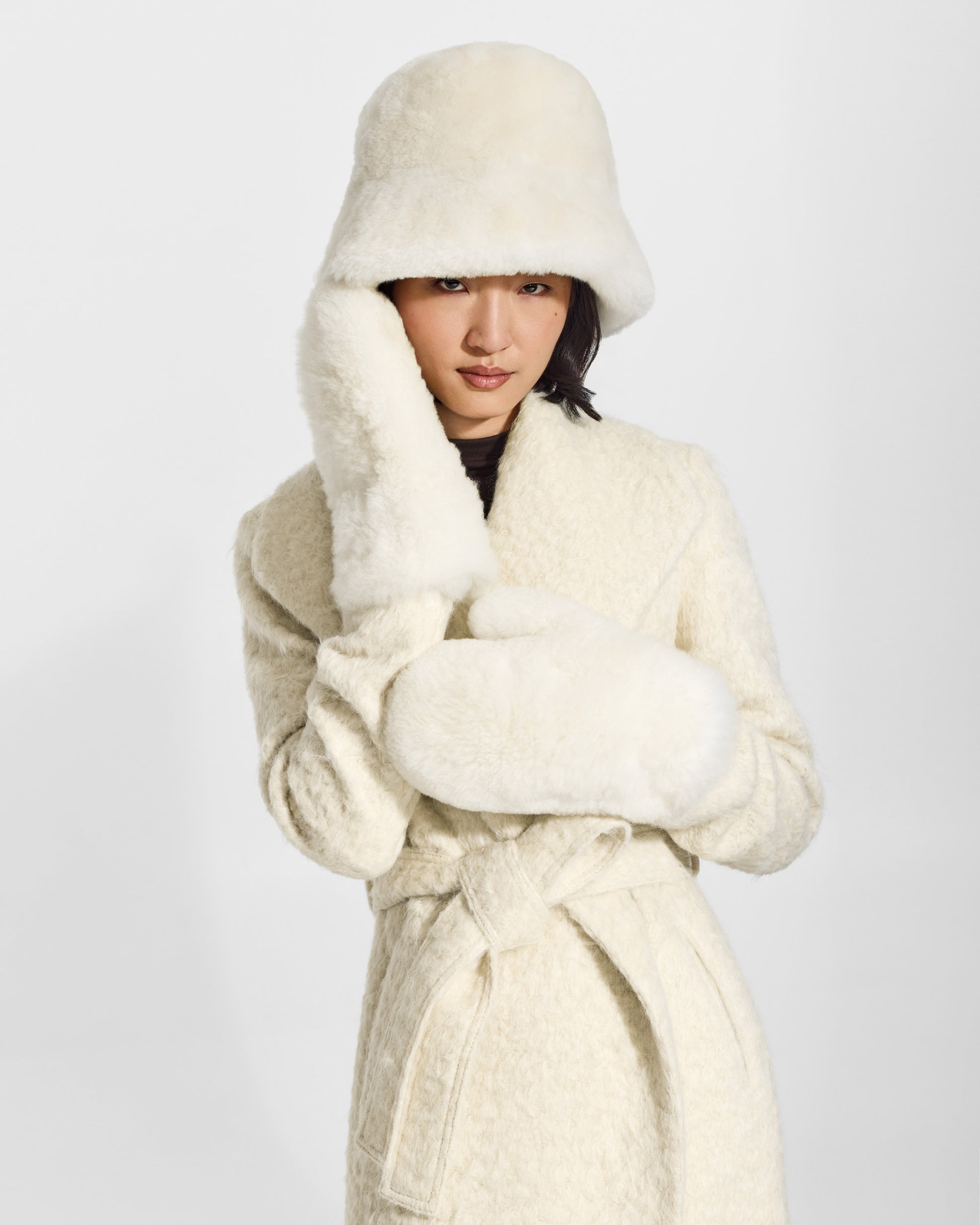 SENTALER Oversized Shearing Mittens in Ivory, Alpaca Shearling. Worn by a female model, front view, close-up.