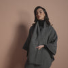 Editorial campaign video of model wearing a Sentaler cape with scarf collar and belt made of baby alpaca wool.