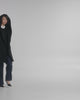 SENTALER Mid Length Hooded Wrap Coat in Black, Baby Alpaca. Product video, worn by a female model, full-length and detail views of the fabric and finishing.
