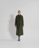 Video of model wearing a SENTALER long olive green wrap coat made of baby alpaca wool, with a large notched collar.