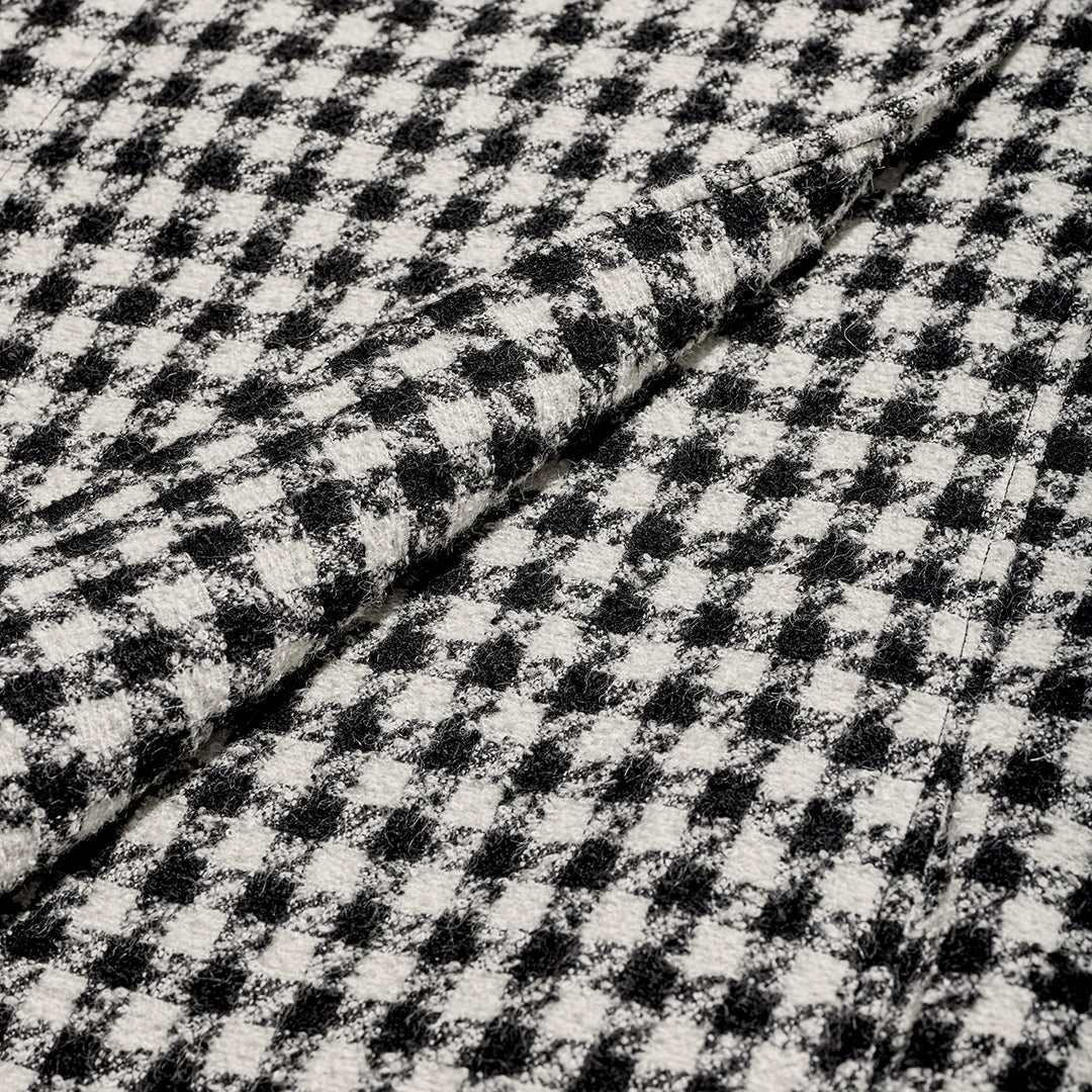 SENTALER Tweed Suri Alpaca fabric swatch in Black & White Houndstooth, folded at centre to show texture and weave.