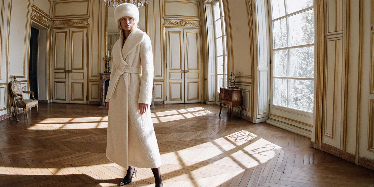 SENTALER Textured Suri Alpaca Maxi Shawl Collar Wrap Coat in Cloud White and belted. Worn with a Shearling Hat in Ivory.