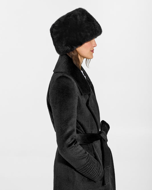 SENTALER Shearling Hat in Black, Alpaca Shearling. Worn by a female model, side view.