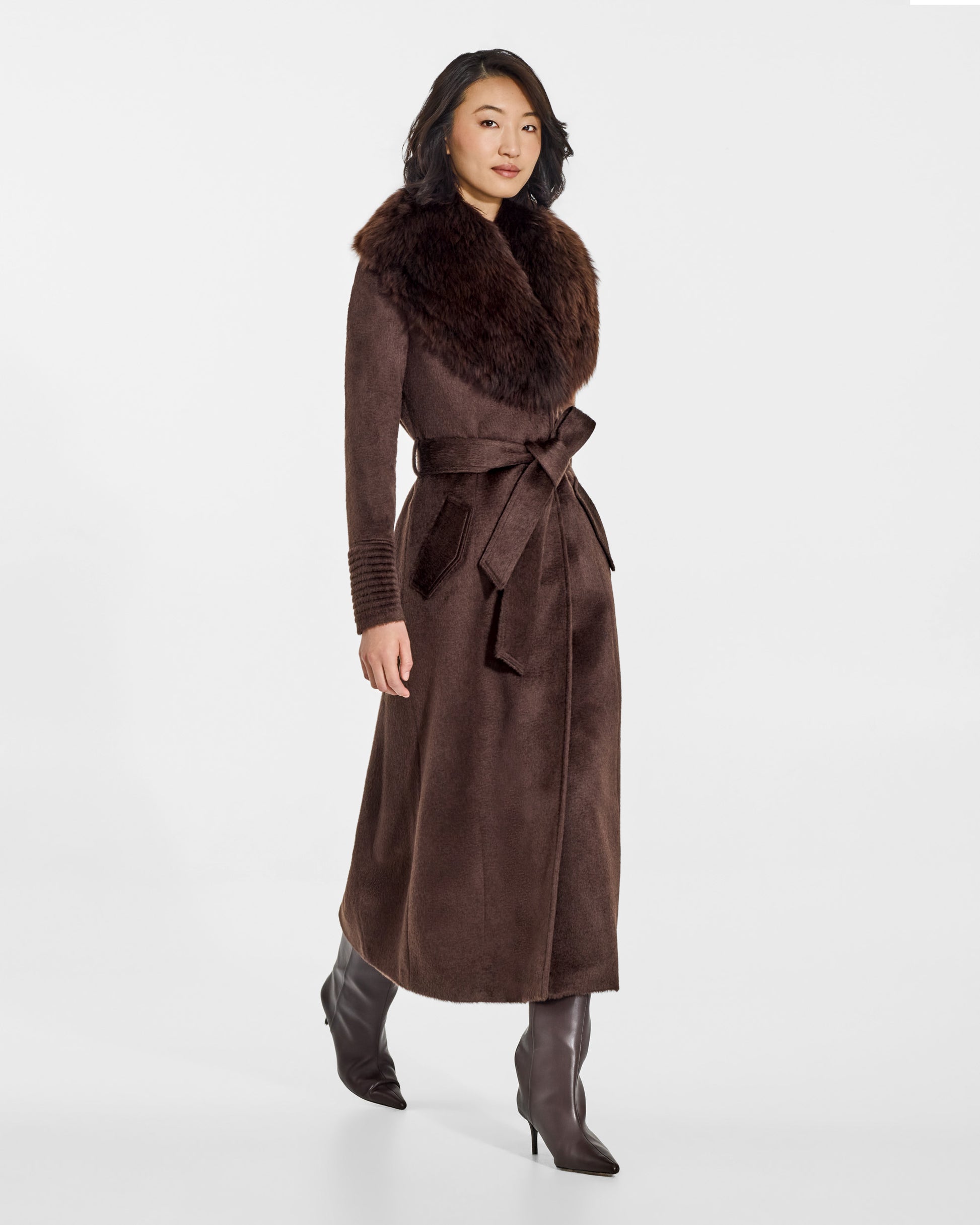 SENTALER Maxi Coat with Alpaca Shearling Collar in Chocolate Brown, Suri Alpaca. Worn by a female model, side view, belted.