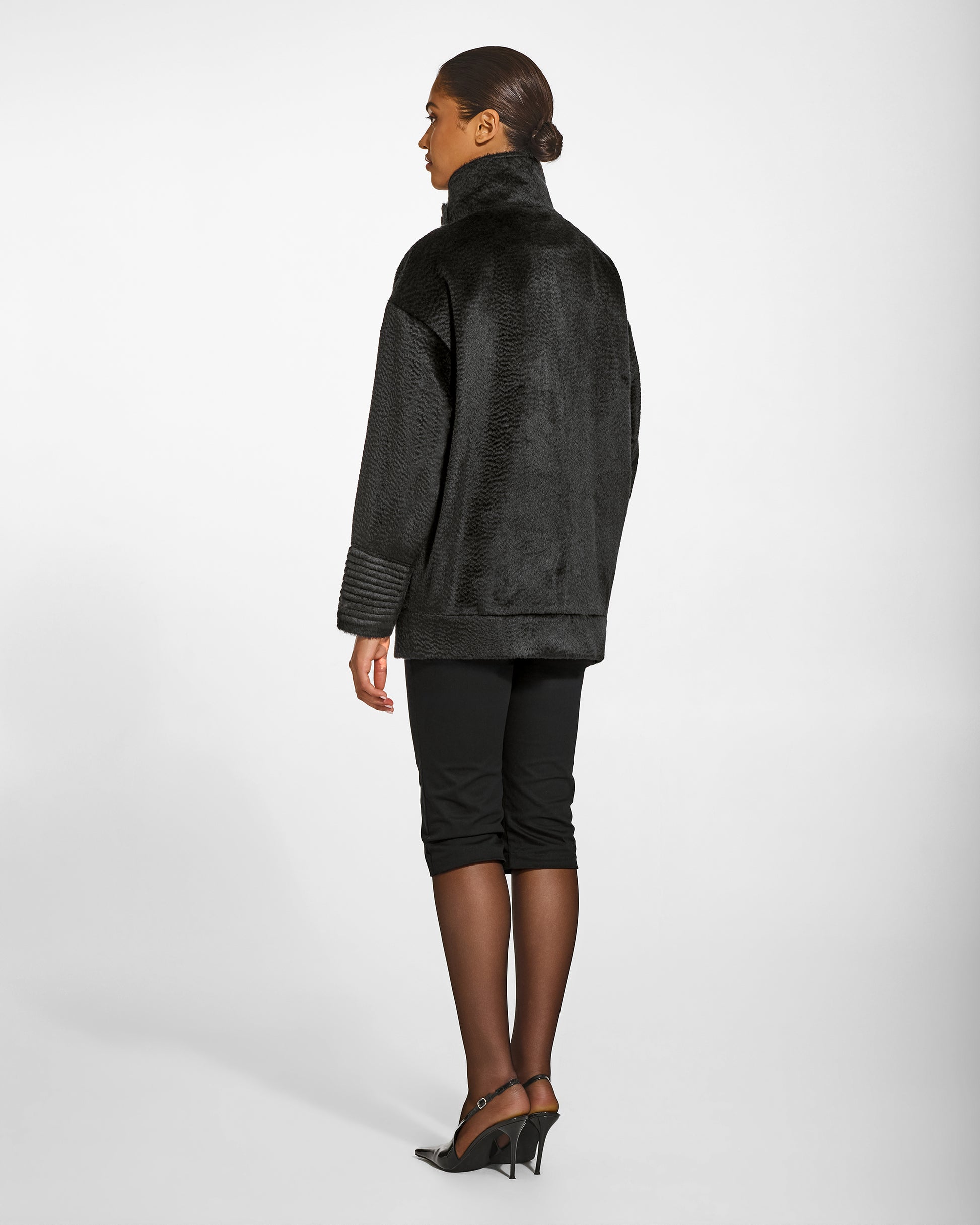 SENTALER Stand Collar Aviator Jacket in Black, Suri Alpaca. Worn by a female model, back view, belted.