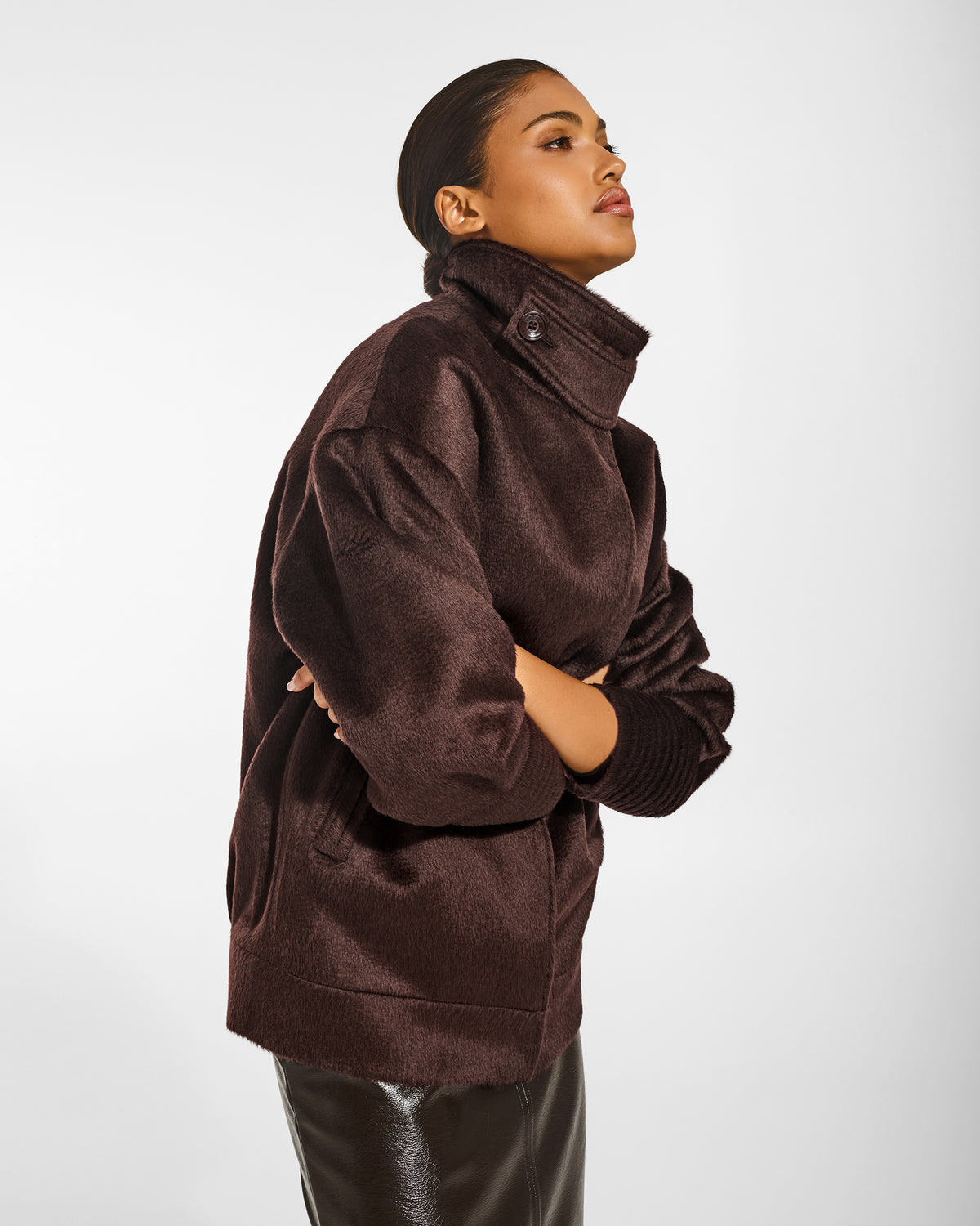 SENTALER Stand Collar Aviator Jacket in Chocolate Brown, Suri Alpaca. Worn by a female model, side view, buttoned, close up.
