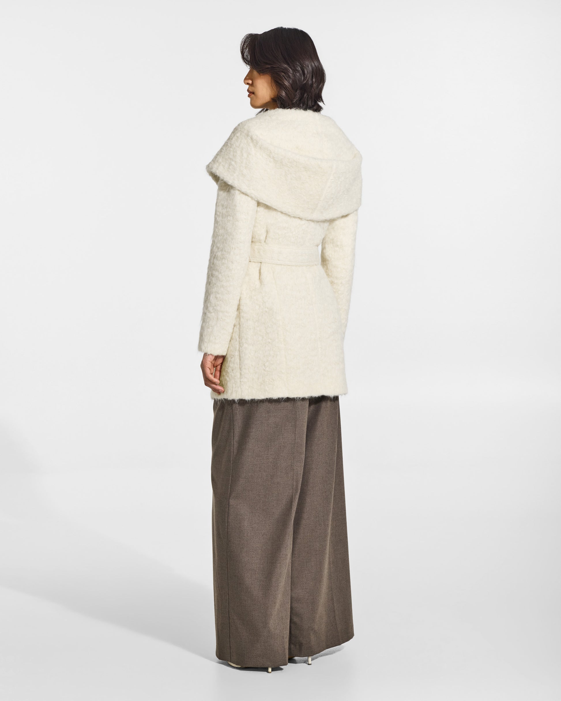 SENTALER Short Hooded Wrap Coat in Cloud White, Textured Suri Alpaca. Worn by a female model, back view, belted.