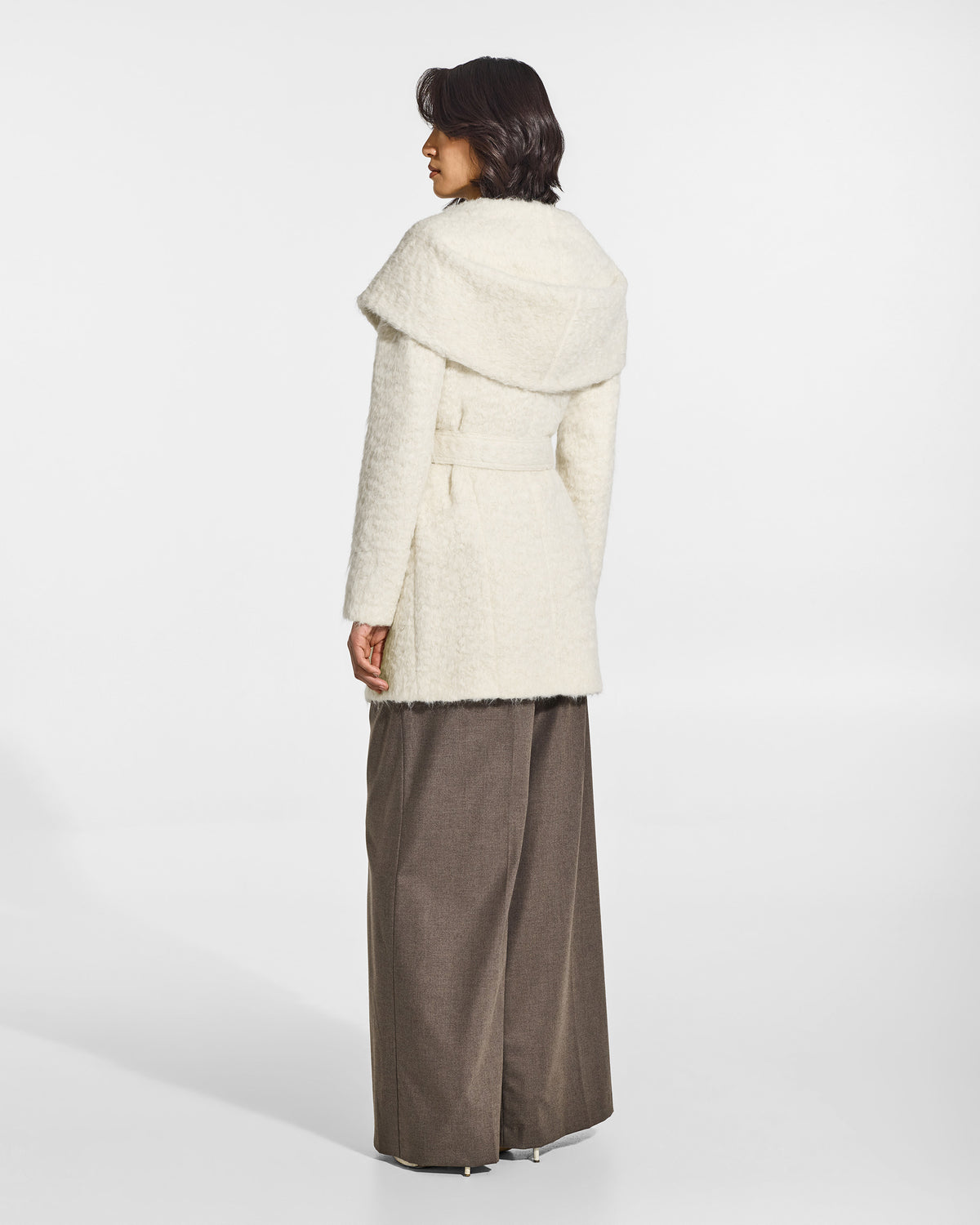 SENTALER Short Hooded Wrap Coat in Cloud White, Textured Suri Alpaca. Worn by a female model, back view, belted.