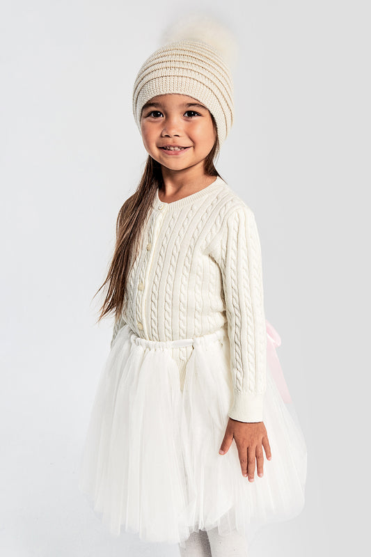 Sentaler Kids (1-5 Years) Ribbed Hat with Oversized Fur Pompon featured in Baby Alpaca and available in Ivory. Seen from front on model.